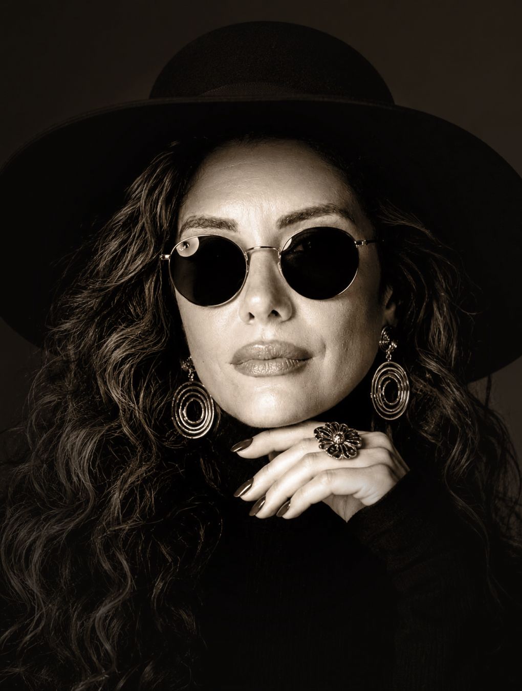 Gamze Sargın — black-and-white portrait with a black hat and round sunglasses